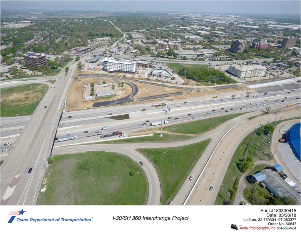 Aerial photograph taken March 2018 over Ballpark Way and I-30 looking northeast. Construction of westbound collector-distributor and northbound Ballpark Way exit to collector-distributor shown mid-ground.