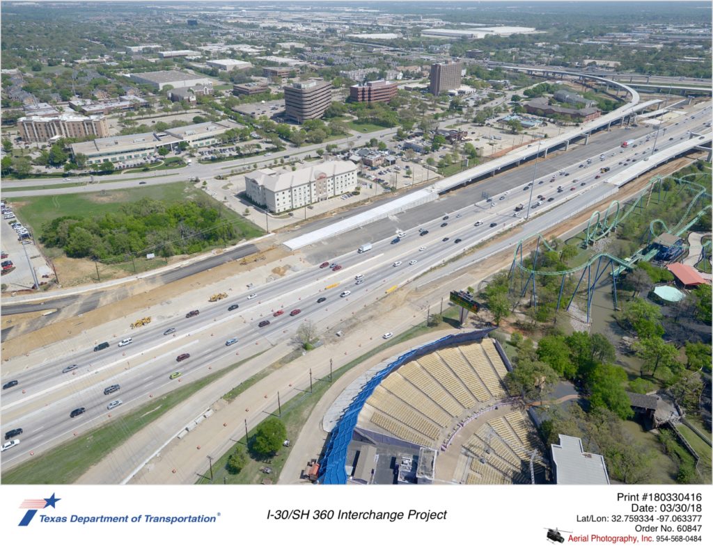 Aerial photograph taken March 2018 over Copeland Rd at Ballpark Way showing construction of new direct connector from southbound SH 360 to westbound I-30, new westbound main lanes, and direct connector from eastbound I-30 to SH 360.