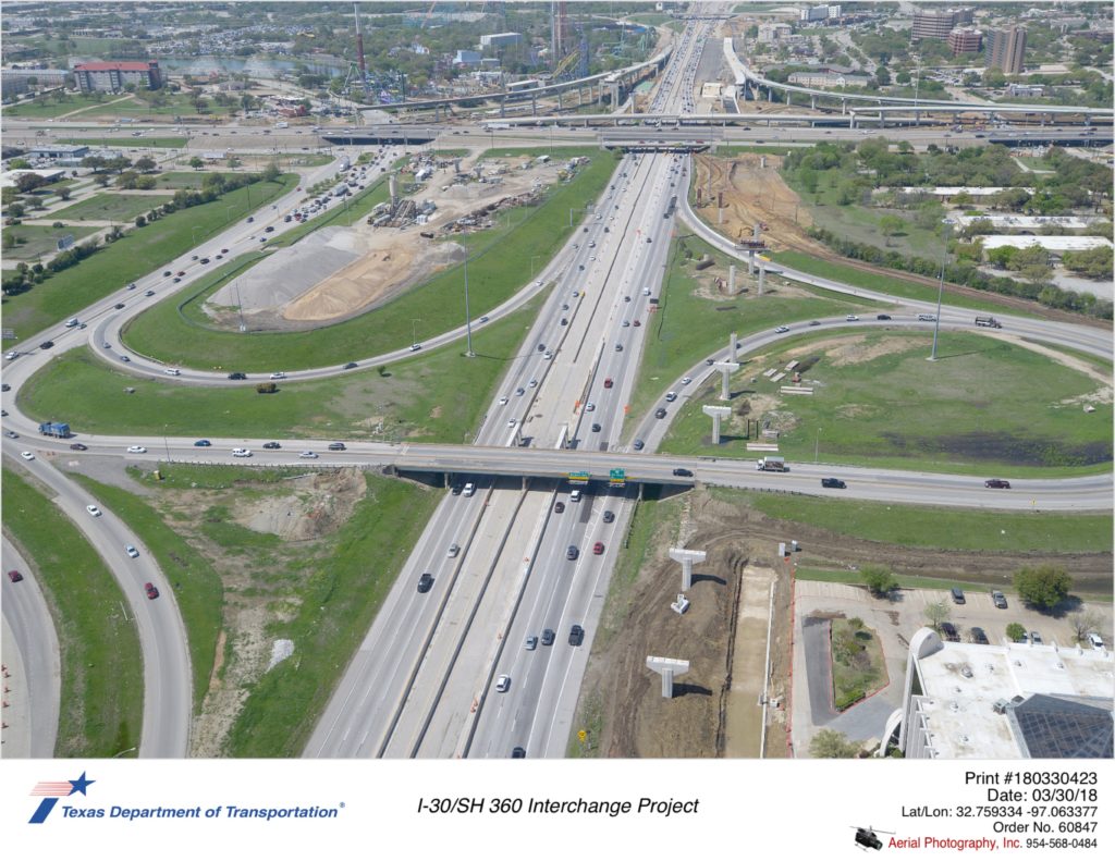 Aerial photography taken March 2018 over I-30  with SH 360 crossing over I-30 in the background. I-30 access ramps to and from SH 360. Future bridge construction work northside of picture.