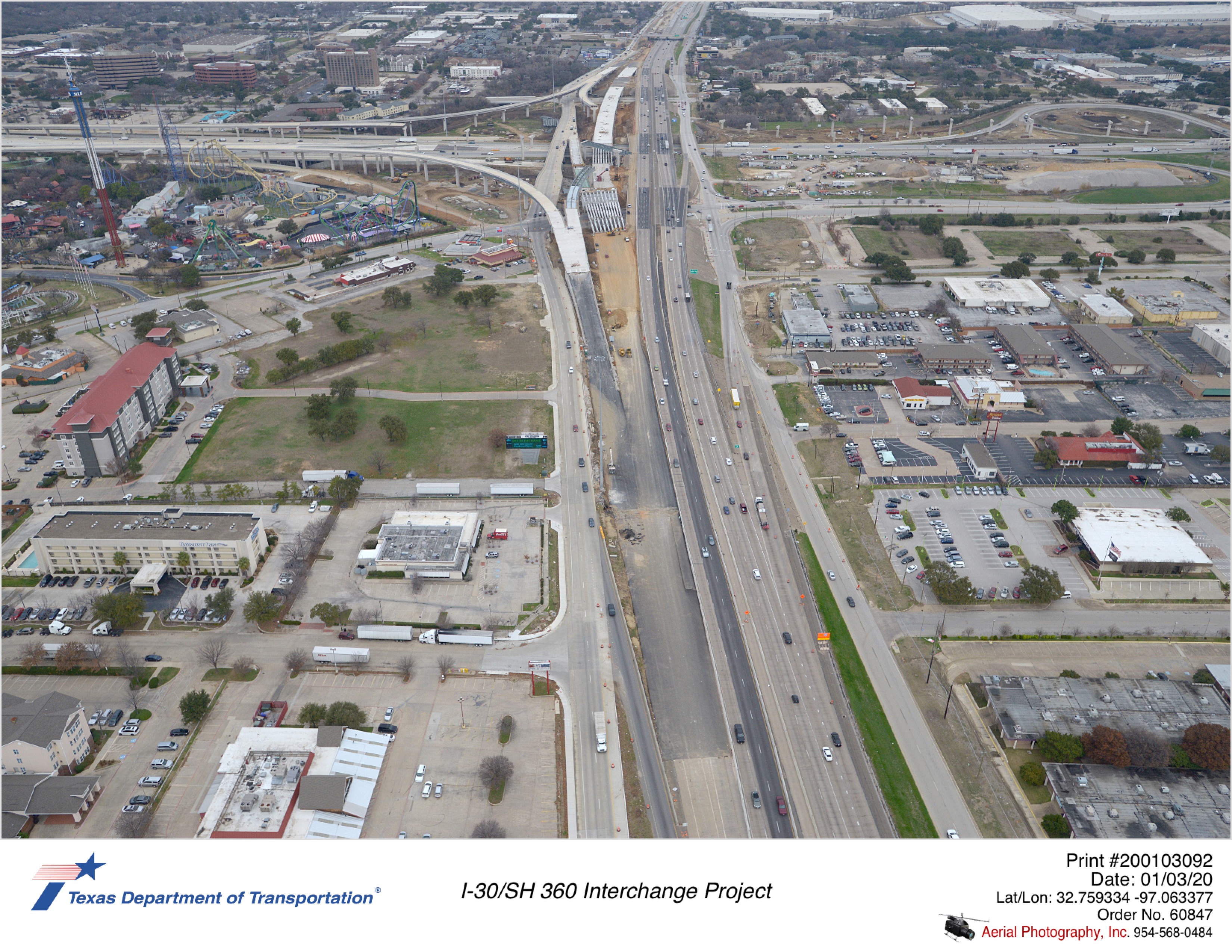 Looking north over SH 360 with I-30 in background. Can see active on the SH 360 southbound mainlane bridge and connection with directional connector ramps.