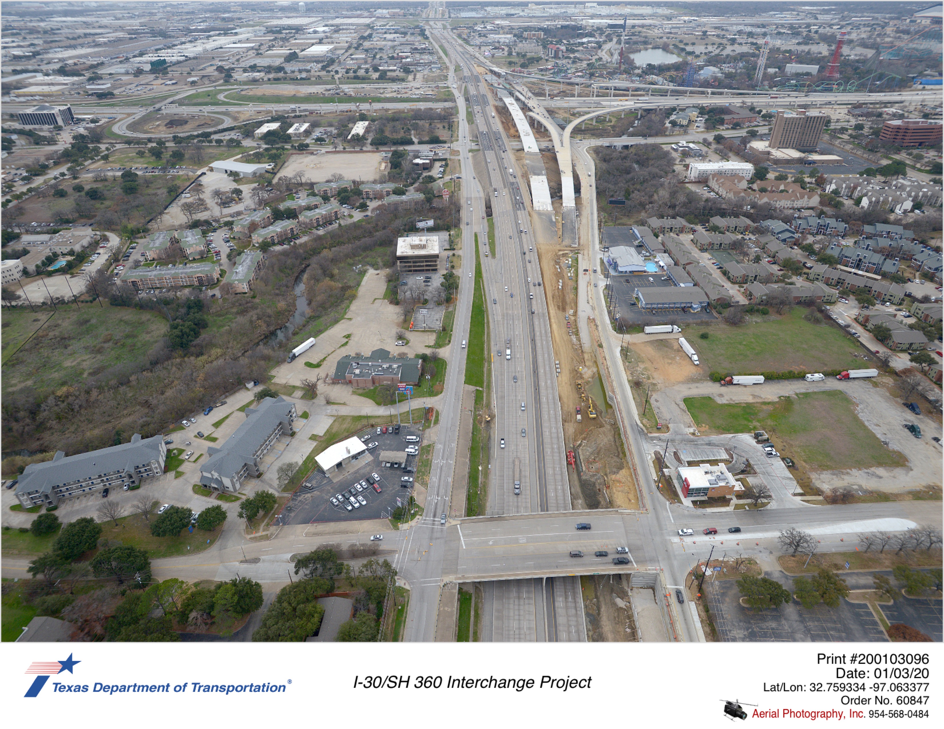 SH 360 looking south with I-30 in background, and Ave J in foreground. Construction of new SH 360 southbound mainlane bridge, pavement, and inside portion of southbound frontage road is shown.