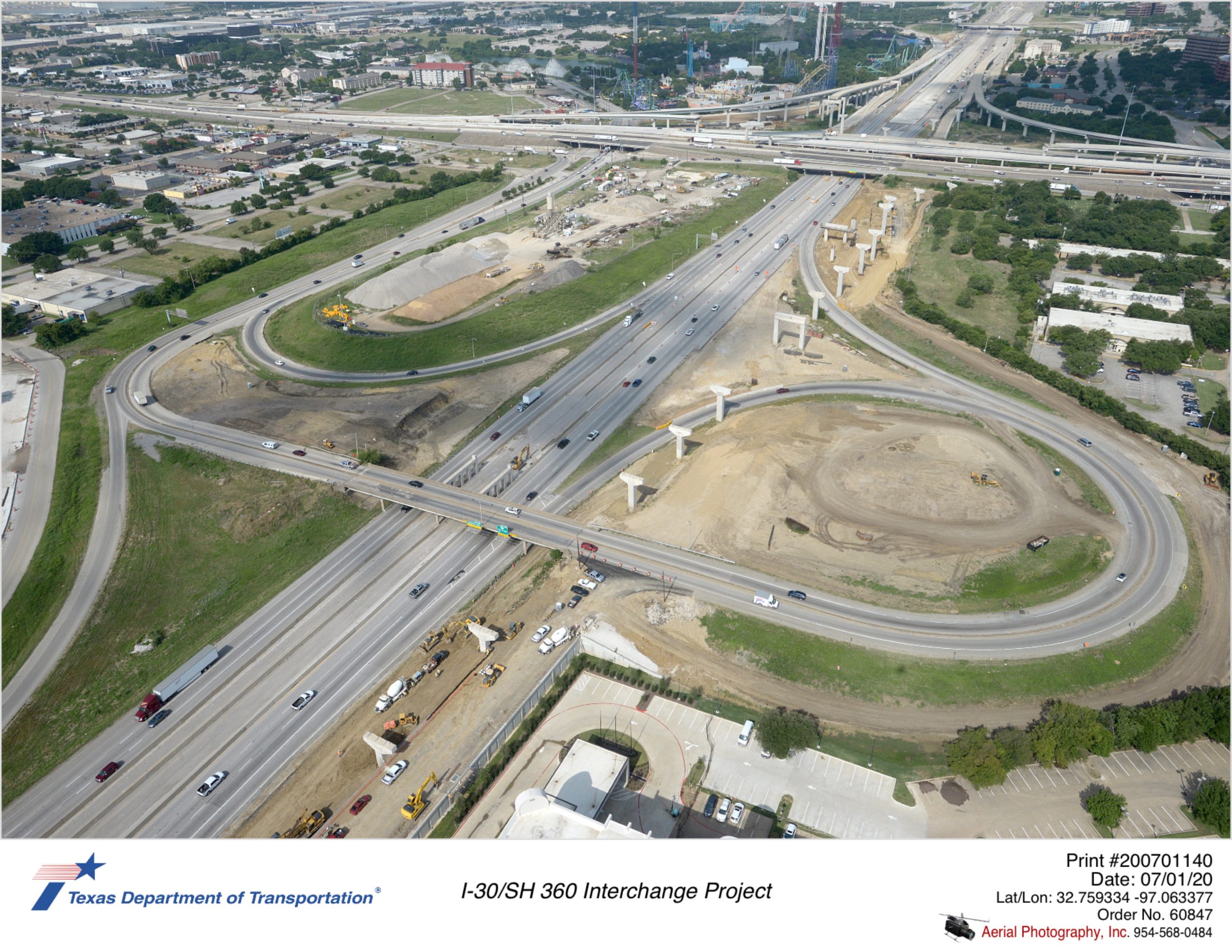 Looking southwest at Six Flags Dr crossing I-30. Future westbound to north and south connector bridges construction shown.