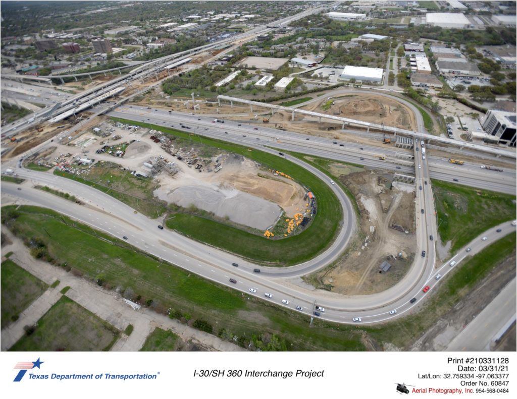 I-30/SH 360 interchange looking north over Six Flags Dr interchange. Focus construction on Six Flags Dr underpass west of existing Six Flags Dr bridge and construction of westbound direct connectors to SH 360.
