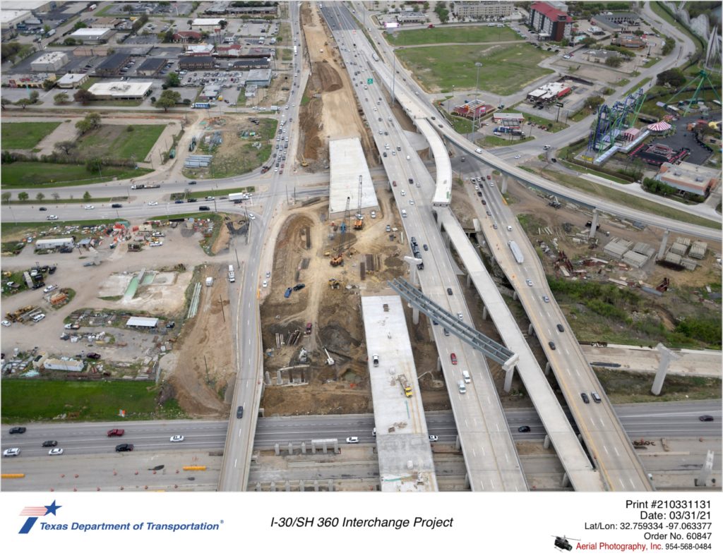 SH 360 looking south over I-30. Focus shows construction of new northbound mainlane bridges over Six Flags Dr and I-30. The start of bridge substructure construction for northbound frontage road bridge over I-30 is evident.