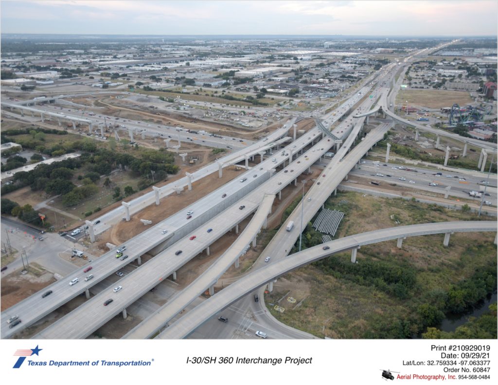 I-30/SH 360 interchange looking southeast over Lamar Blvd. New northbound frontage road over I-30, bridge structure work are shown.