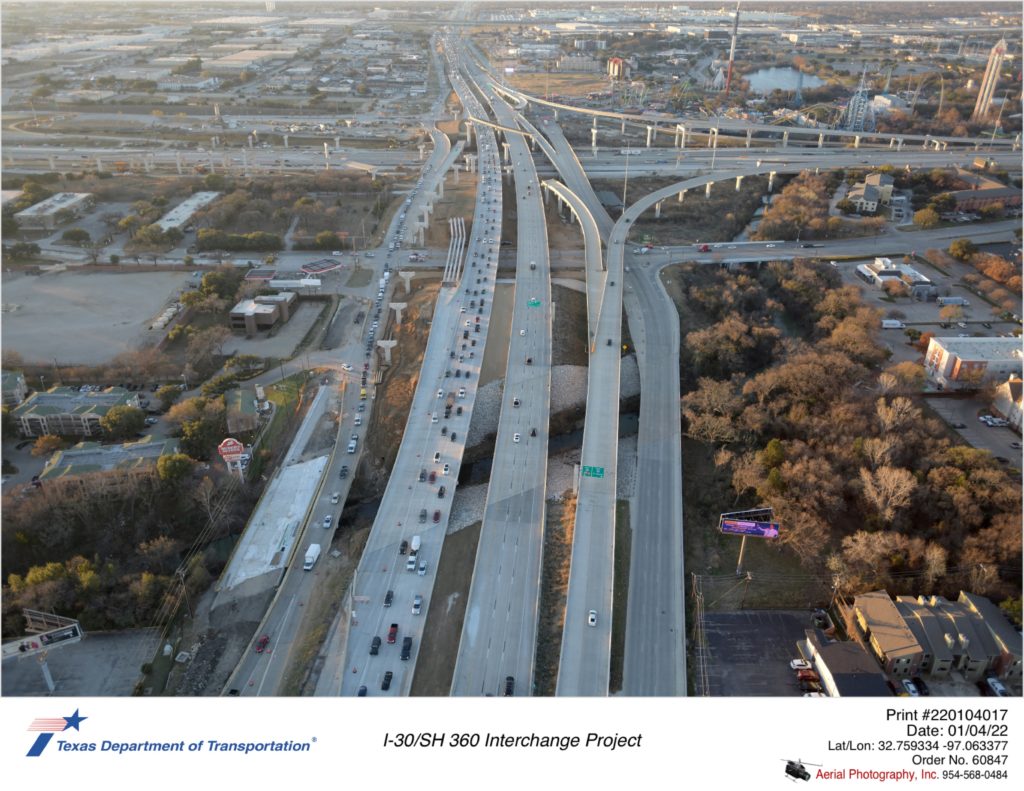 SH 360 looking south over Johnson Creek and Lamar Blvd. Construction of SH 360 northbound frontage road and direct connector bridges from I-30 across Lamar Blvd is shown.