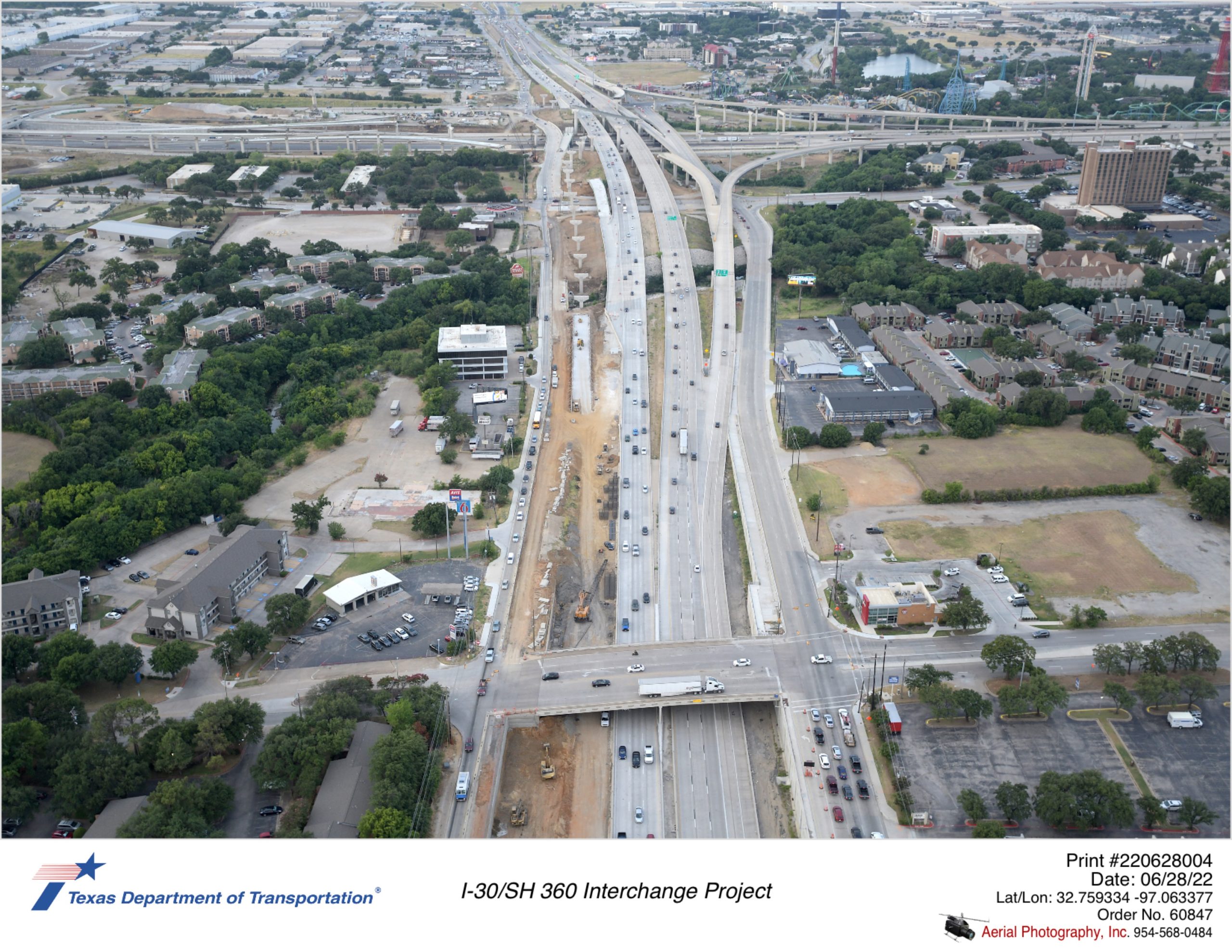 SH 360 looking south over Ave J interchange shown in foreground. Construction of northbound frontage road and retaining walls facing northbound mainlanes is shown.