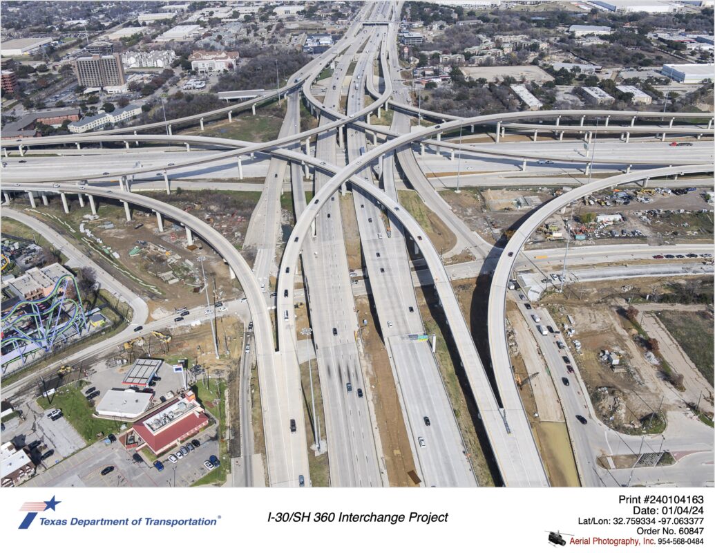 SH 360 and I-30 interchange looking north at Six Flags Dr in frame. Construction of Six Flags Dr and frontage roads intersecting Six Flags Dr shown.